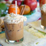 Iced Coffee drink with wyhipped cream and cinammon sticks